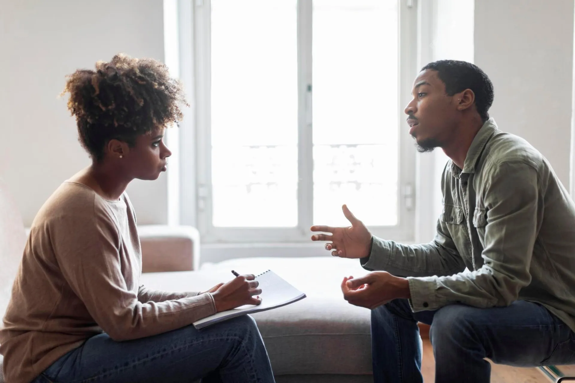black-man-sharing-feelings-thoughts-with-therapist Black Man Sharing Feelings Thoughts With Therapist